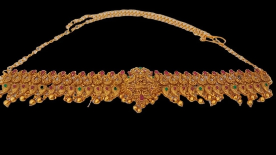 Stunning antique gold kamarband with intricate detailing and colorful stones.