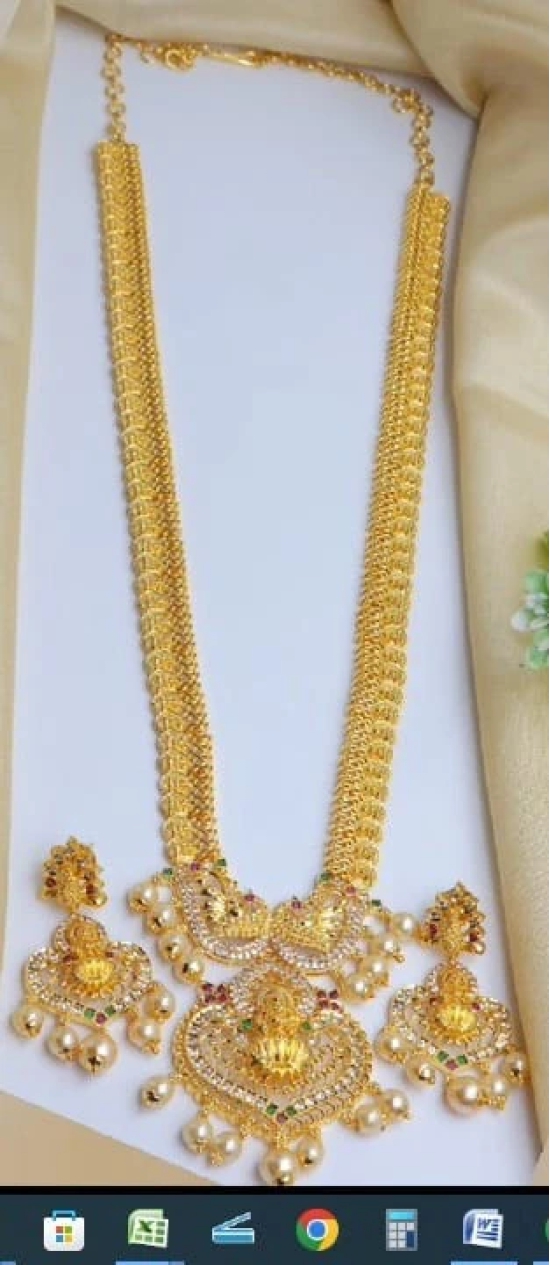  Gold-plated, long necklace with intricate detailing and pearl accents