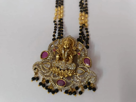 Stunning antique gold plated Goddess Lakshmi earrings with intricate detailing and black beads.